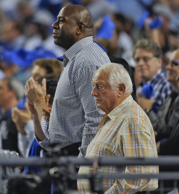 Tommy Lasorda and Earvin "Magic" Johnson watch a Dodger game.