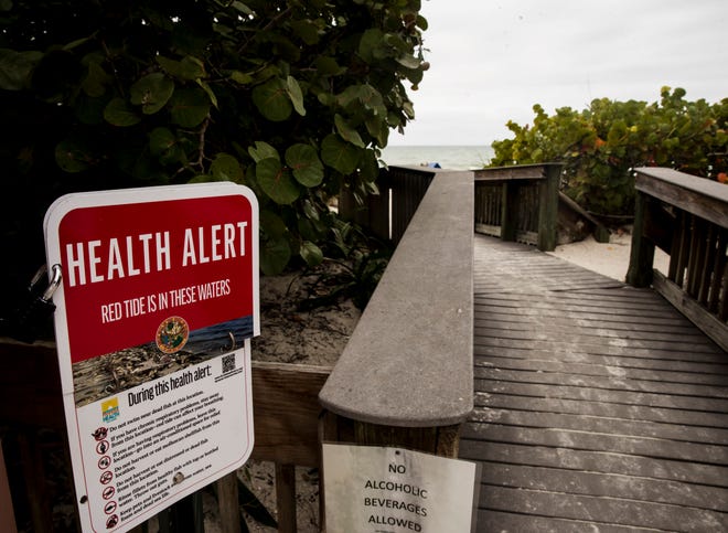 A red tide alert sign is seen Bonita Beach on Thursday, December 17, 2020. Red tide is present in the area.