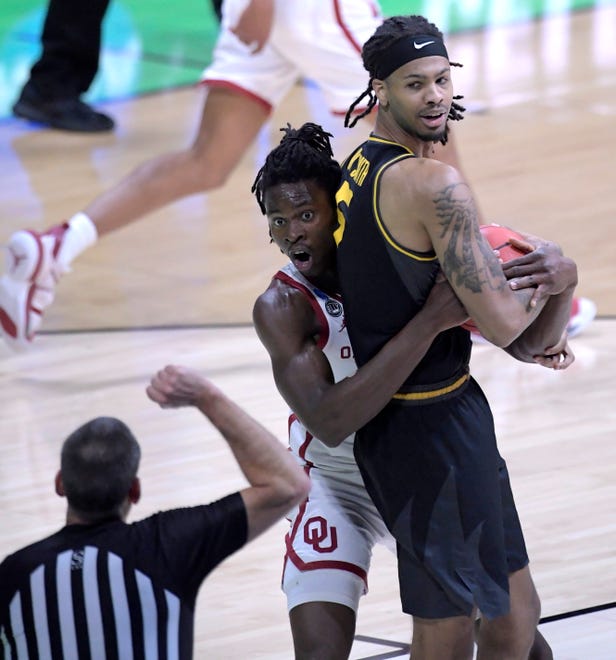 First round: Oklahoma's Victor Iwuakor reacts to an official's call as he defends Missouri forward Mitchell Smith during their game at Lucas Oil Stadium.