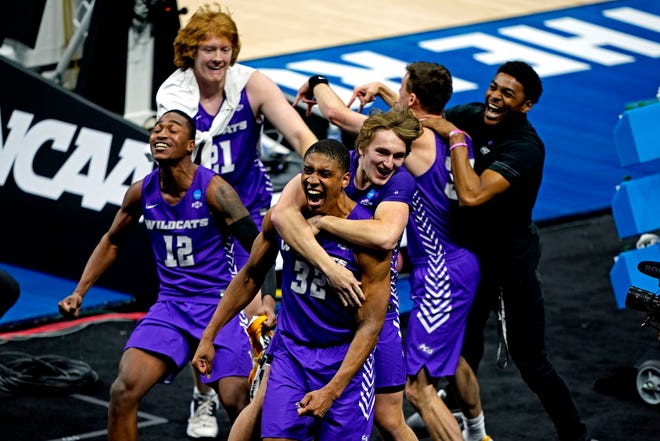 First round: The Abilene Christian Wildcats celebrate with forward Joe Pleasant (32) after defeating the Texas Longhorns at Lucas Oil Stadium.