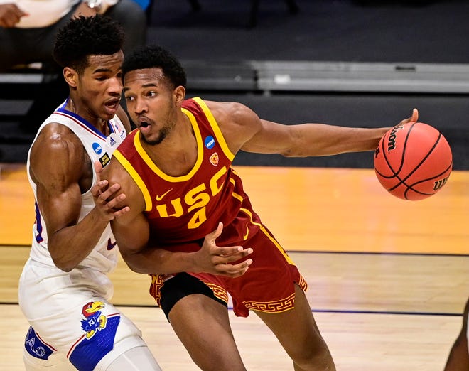 Second round: USC's Evan Mobley (4) handles the ball while Kansas' Ochai Agbaji (30) defends  during the first half at Hinkle Fieldhouse. USC won the game, 85-51.