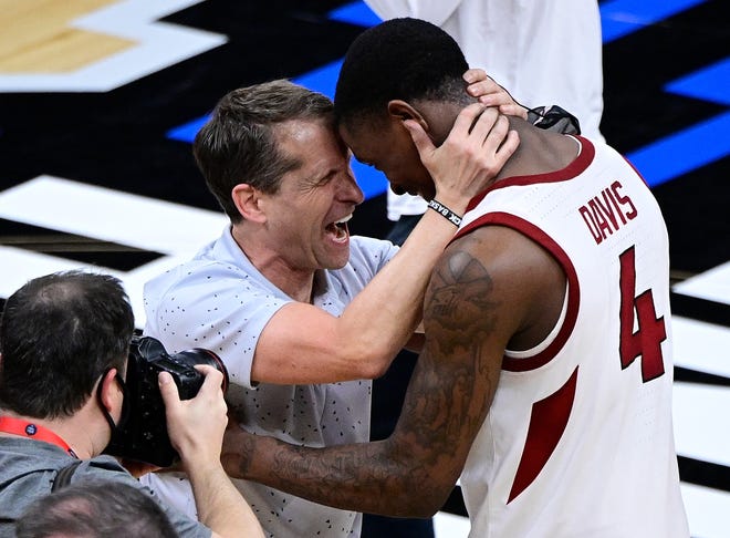 Sweet 16: Arkansas Razorbacks head coach Eric Musselman celebrates with guard Davonte Davis (4) after the Razorbacks defeated Oral Roberts Golden Eagles in the 2021 NCAA Tournament at Bankers Life Fieldhouse on March 27, 2021. Arkansas beat Oral Roberts 72-70.