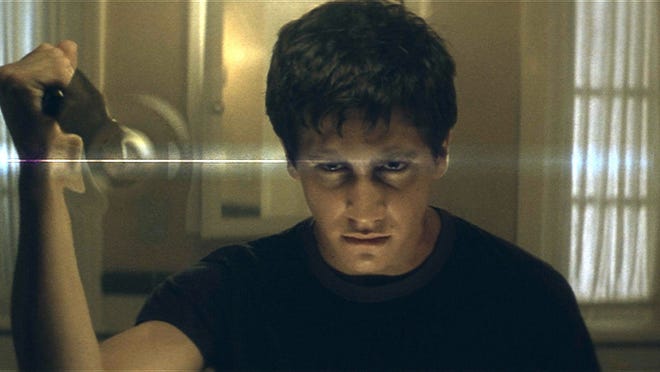 11. " Donnie Darko " (2001) • Director: Richard Kelly • Cast: Jake Gyllenhaal, Jena Malone, Mary McDonnell • Domestic box office: $1.5 million Troubled teenager Donnie Darko (Jake Gyllenhaal) survives a freak accident after which he starts to have visions of a man in a rabbit suit who tempts him to alter time and commit crimes. The film holds a Certified Fresh status on Rotten Tomatoes, with 86% of critics and 80% of fans giving it a positive rating.