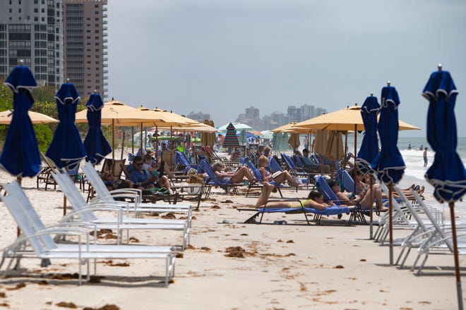 Beachmoor residents and guest relax , Monday, April 12, 2021, at Vanderbilt Beach in Naples. Naples residents will likely pay higher property taxes next year.