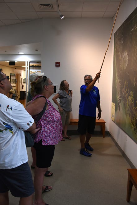 Volunteer docent Paul Westberry explains the reserve's sweep to visitors. The Rookery Bay Environmental Learning Center has reopened, with new exhibits and activities, after being closed over a year due to COVID-19.