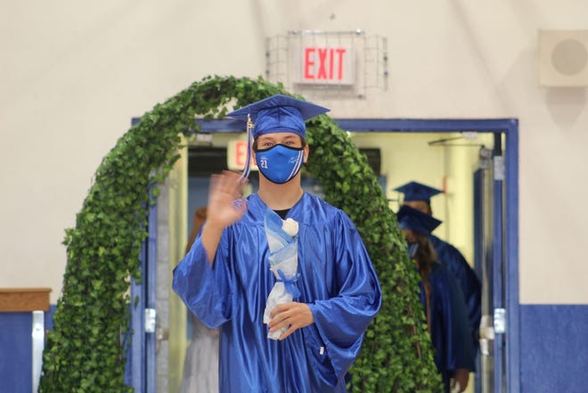 Daniel Gibson waves to his family at the graduation for Everglades City School on Friday, May 28, 2020, in Everglades City.