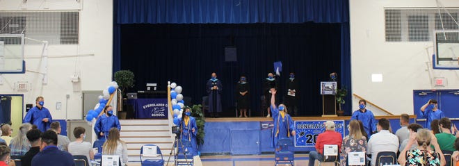 Everglades City School seniors toss their caps at their graduation on Friday, May 28, 2020, in Everglades City.
