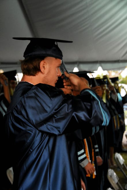 Students perform the ritual turning of the tassels. Marco Island Academy graduated its senior class Friday evening in a commencement ceremony at Veterans' Community Park.