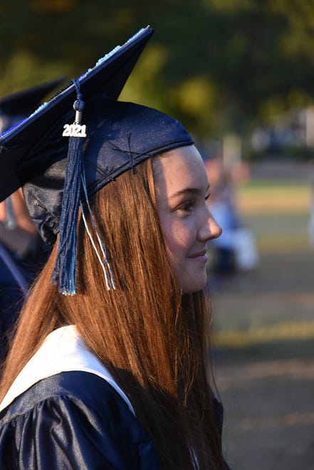 Graduate Emma Blankenship watches her classmates receive their diplomas. Marco Island Academy graduated its senior class Friday evening in a commencement ceremony at Veterans' Community Park.