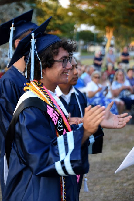 Principal's Award winner Joey Puell applauds his fellow graduates. Marco Island Academy graduated its senior class Friday evening in a commencement ceremony at Veterans' Community Park.