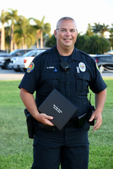 MIPD Officer Paul Ashby accepted the diploma for his son Keaton Ashby. Marco Island Academy graduated its senior class Friday evening in a commencement ceremony at Veterans' Community Park.