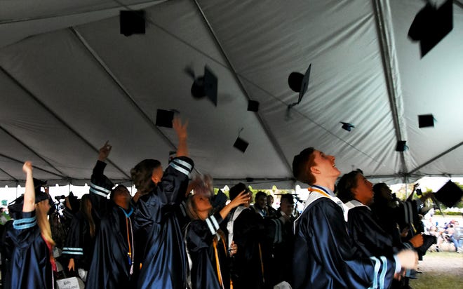 After the ritual turning of the tassels, students toss their mortarboards aloft. Marco Island Academy graduated its senior class Friday evening in a commencement ceremony at Veterans' Community Park.