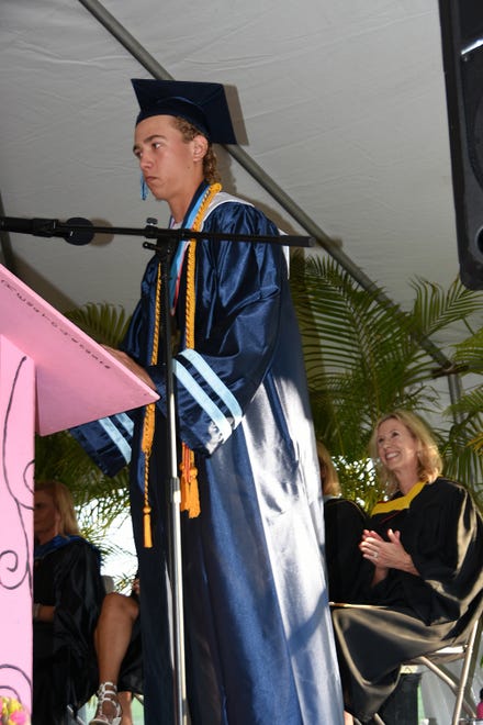 Co-valedictorian Johnathan Watt speaks, watched by his proud mother, school founder Jane Watt. Marco Island Academy graduated its senior class Friday evening in a commencement ceremony at Veterans' Community Park.