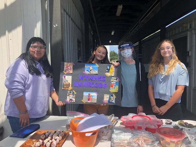 Arlette Villegas- Hernandez, from left, Makayla Hendrick, Phoenix Gutierrez, and Elle Richardson work the club's bake sale. Members of Marco Island Academy's Key Club raised funds to help three-year-old Wynne Lockwood, who suffers from a rare disease.