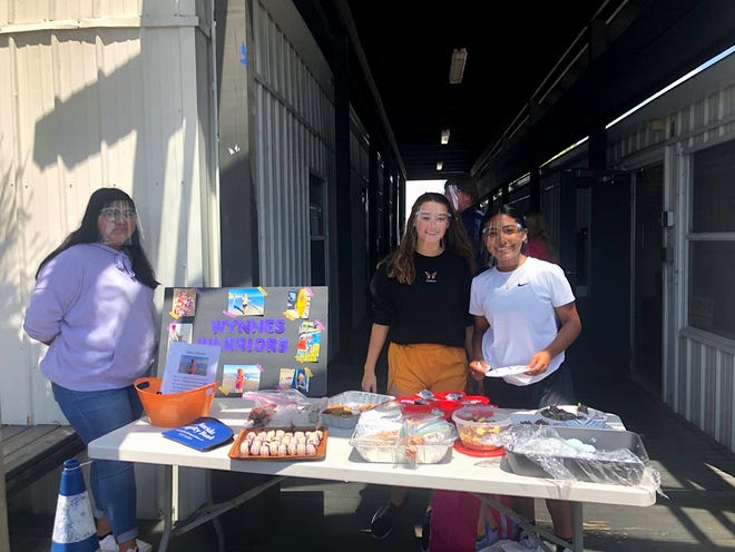 Arlette Villegas- Hernandez, from left, Makayla Hendrick, and Phoenix Gutierrez work the club's bake sale. Members of Marco Island Academy's Key Club raised funds to help three-year-old Wynne Lockwood, who suffers from a rare disease.