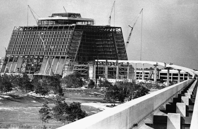 July 7, 1971: Monorail tracks and concrete pilings lead into contemporary hotel under construction at Walt Disney World in Orlando, Florida. The tracks go through the 1,057-room,9-level A-frame hotel.