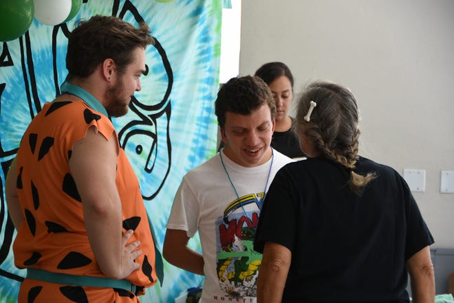 Counselor Smith McWaters, left, greets camper Michael. Camp Able provided a week of fun and activities for folks with diverse abilities, headquartered at Wesley United Methodist Church Marco.