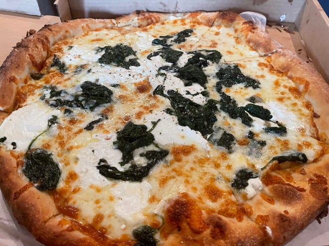 The large white pizza with spinach from Joey's Pizza & Pasta, Marco Island.