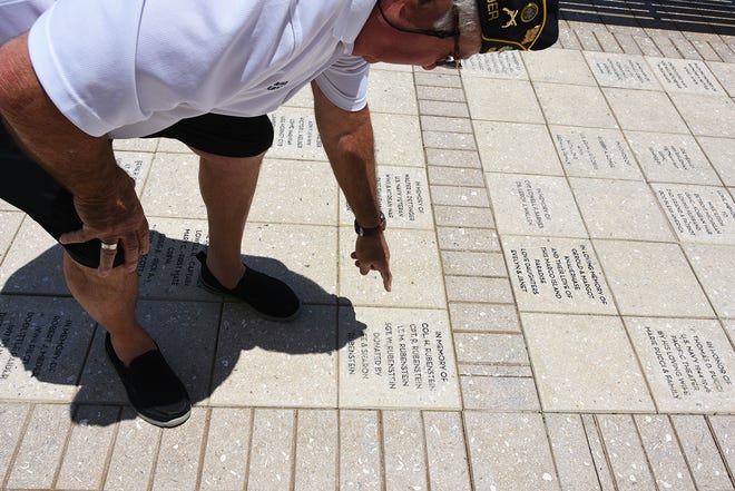 Lee Rubenstein points out a brick dedicated to an ancestor who died in World War I. The Marco Island American Legion post proposes to fund and erect a replica of the Vietnam Veterans Memorial "Three Servicemen" statue in Veterans' Community Park.