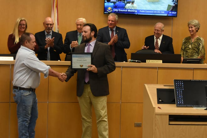 Frank Clark of the utilities deptl, left, is honored as city employee of the quarter.The Marco Island City Council met in a lengthy series of meetings July 19 at the council chambers.