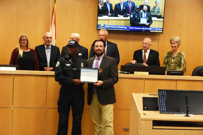 Firefighter Anthony Gordon, left, receives recognition for five years of service from Council Chair Jared Grifoni. The Marco Island City Council met in a lengthy series of meetings July 19 at the council chambers.