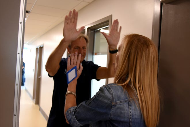MIA Principal Melissa Scott, right, gets a high five from benefactor Mark Melvin. For Marco Island Academy, August 10 was not only the first day of school, but the first day ever in their new state-of-the-art $15 million dollar building.
