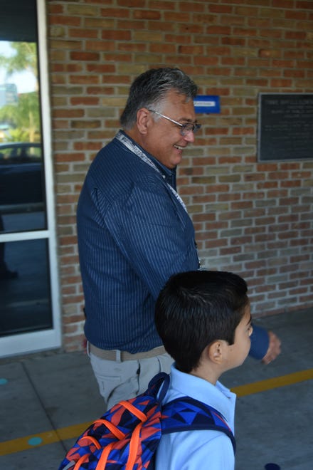 Music teacher Craig Greusel directs a new student to his class at Tommie Barfield Elementary. Marco Island schoolchildren, along with all of southwest Florida's public school students, returned for the new school year on Tuesday.