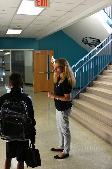 MICMS Principal Michele Wheeler helps a student find his classroom. Marco Island schoolchildren, along with all of Southwest Florida's public school students, returned for the new school year on Tuesday.