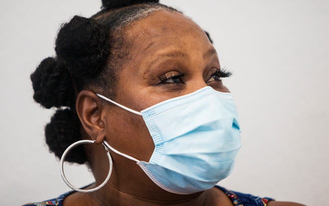 Fort Myers resident, Carleather Atkins waits the requisite 15 mintues after receiving her second dose of the Moderna vaccine from Dr. Shadreka McIntosh, owner of Sozo Wellness Pharmacy on Martin Luther King Jr. Boulevard on Wednesday, August 18, 2021.  Atkins said McIntosh persuaded her to get the vaccine. "It's on everbody's doorstep, " She said about the COVID-19 pandemic.  She said that five of her family members were in the hospital at the same time with COVID-19.