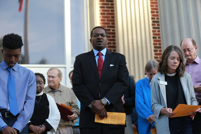 Rev. John Perry, a candidate for Brunswick Mayor, offers a prayer as motion hearings were set to begin in the trail of the 3 men accused of killing Ahmaud Arbery Monday morning on the steps of the Glynn County Courthouse in Brunswick Georgia.