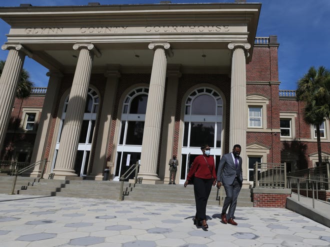 Wanda Cooper-Jones exits the Glynn County Courthouse with her attorney Lee Merritt after a lunch break on Monday October 18, 2021. Jury Selection is expected to begin during the afternoon session.