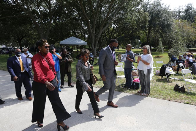Wanda Cooper-Jones passes supporters as she walks to the entrance of the Glynn County Courthouse with her attorney Lee Merritt on Monday October 18, 2021.