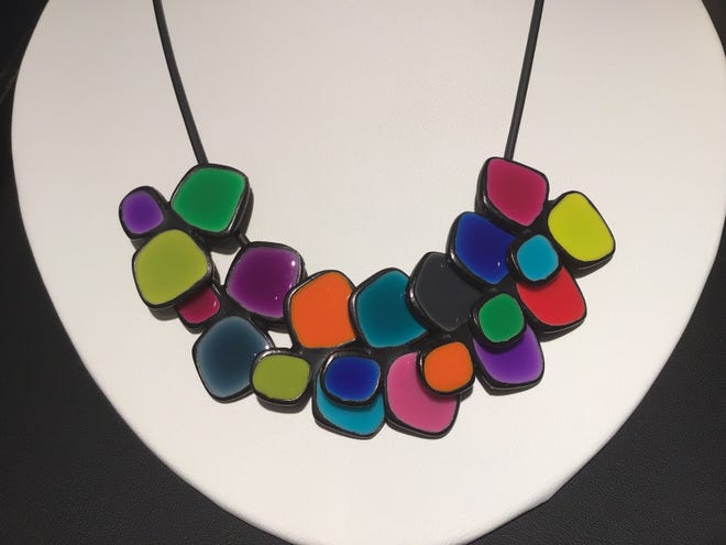 This Thierry Joo enamel necklace ($150) goes with every color she owns. At The Baker Museum gift shop.