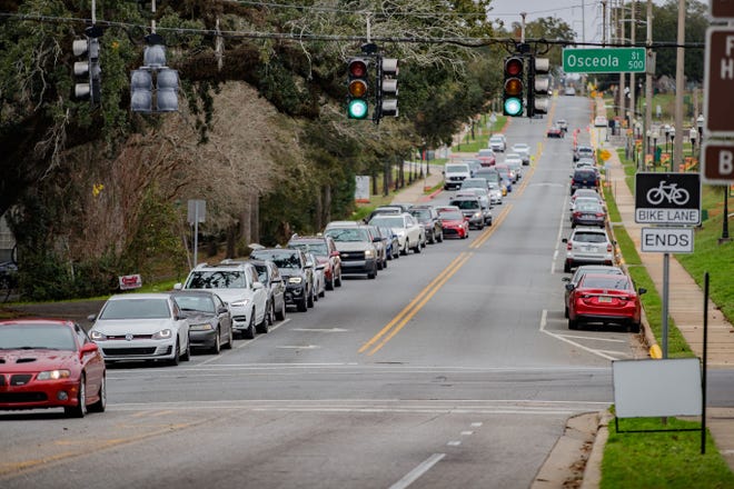 People wait in line in there vehicles backed up in both directions on Wanish Way before getting tested for COVID-19 at the FAMU testing site Monday, Jan. 3, 2022.