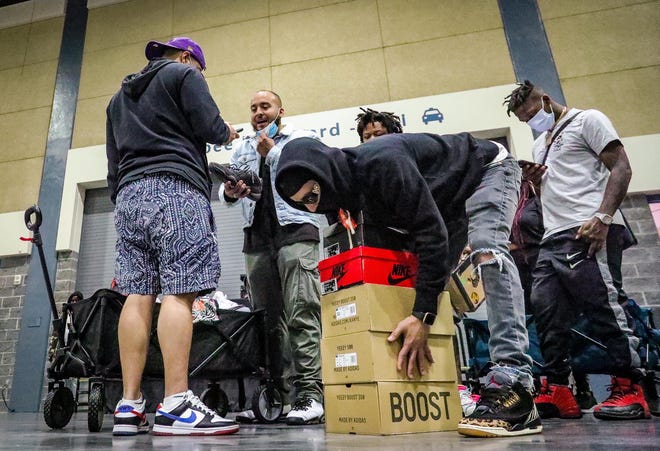 Jason Rodriguez of New York City organizes boxes of his shoes during the Sneaker Exit trade show at the Palm Beach Convention Center Sunday, January 16, 2022.