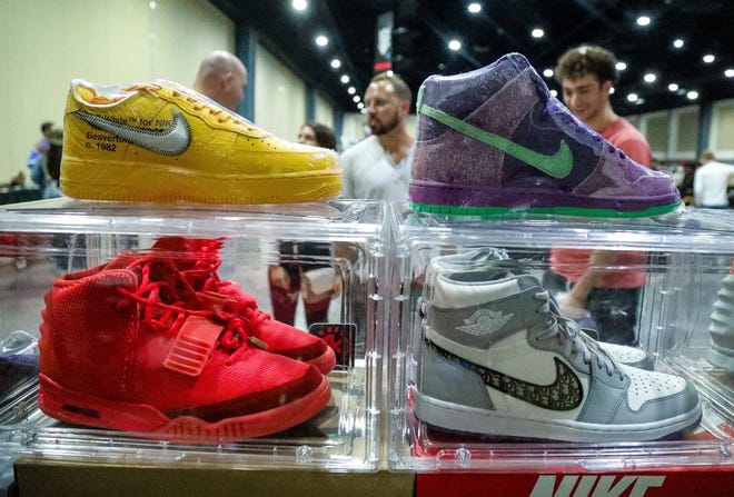 Shoes stacked in transparent displays are for sale at the Ross Kicks booth during the Sneaker Exit trade show at the Palm Beach Convention Center Sunday, January 16, 2022.