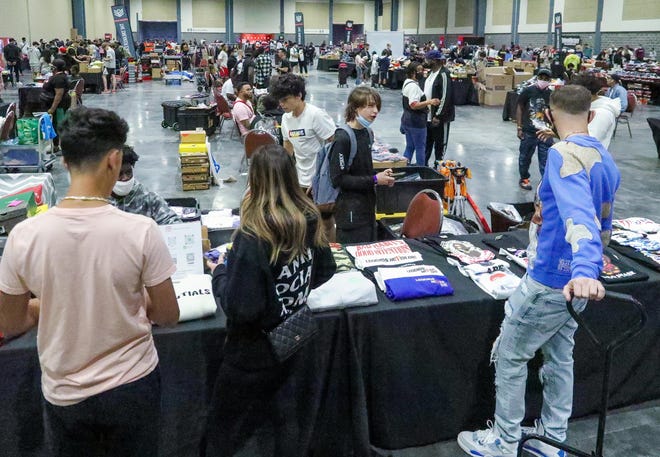 People look to make deals for sneakers during the Sneaker Exit trade show at the Palm Beach Convention Center Sunday, January 16, 2022.