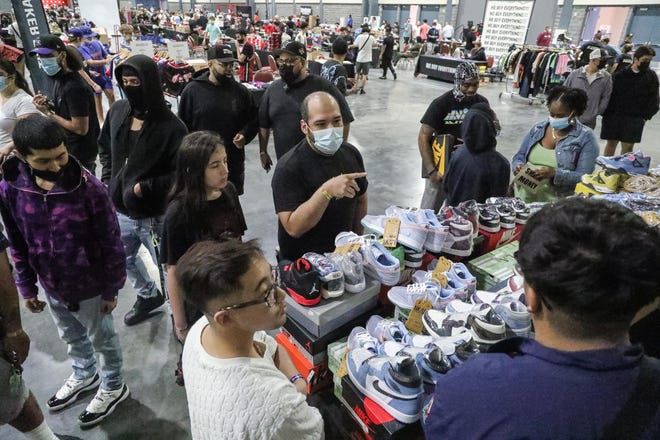 People look to make deals for sneakers during the Sneaker Exit trade show at the Palm Beach Convention Center Sunday, January 16, 2022.