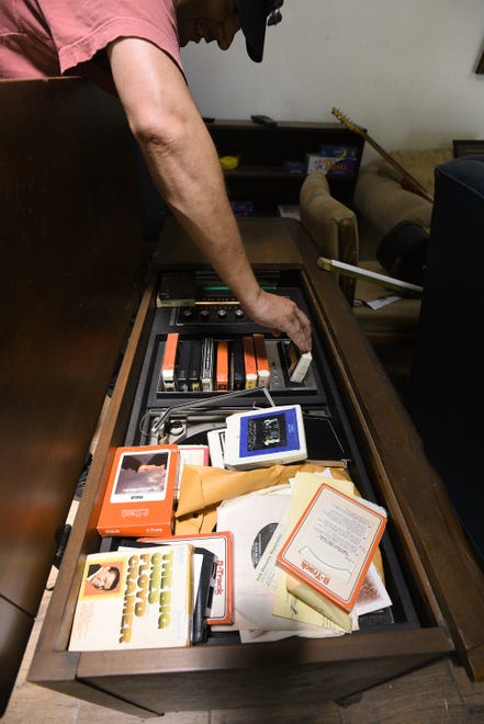 Todd Smith puts a tape into the functioning 8-track cassette player and turntable console complete with Lynyrd Skynyrd tapes. Plans were for these to be a part of the renovated Van Zant family home.