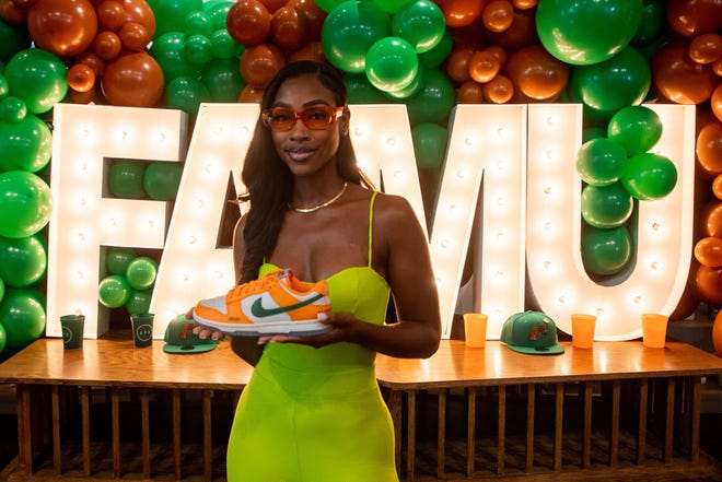 Caitlyn Davis, a Florida A&M University alumna, holds a sneaker that she designed after she teamed up with Nike to create a shoe inspired by FAMU. The shoe was released as part of the "HBCU Dunk Lows" collection.