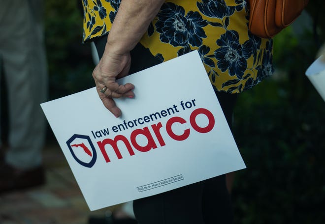A Marco Rubio supporter is seen holding a campaign sign during an event for Senator Marco Rubio's re-election campaign held at the Sims House on Thursday, October 27, 2022, in Jupiter, FL.