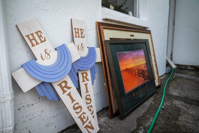 Signs and photos dry in the sun outside the Redemption Church after flooding from Hurricane Idalia damaged the building in Crystal River, Florida on August 31, 2023.